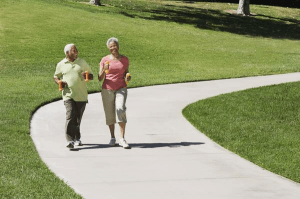 seniors exercising by taking a walk outside of their senior housing
